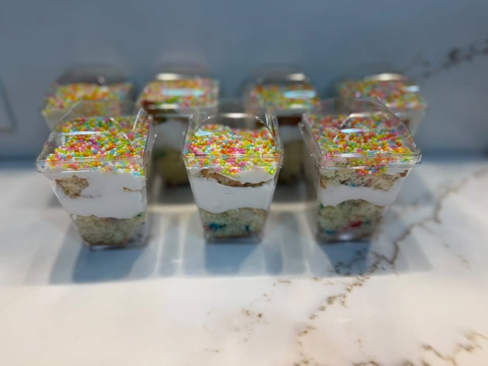 Funfetti cake cups layered with vanilla cake, cream, and rainbow nonpareil sprinkles.