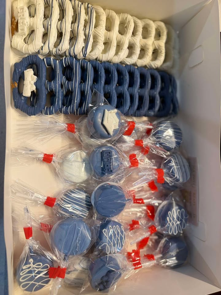 Navy, white and red dipped Oreos, pretzels and cake pops boxed and individually wrapped.
