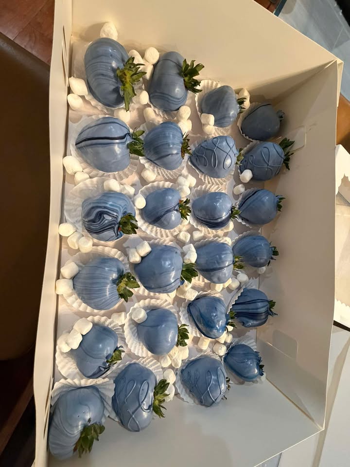 Dusty blue dipped strawberries drizzled in white and nestled among mini marshmallows.